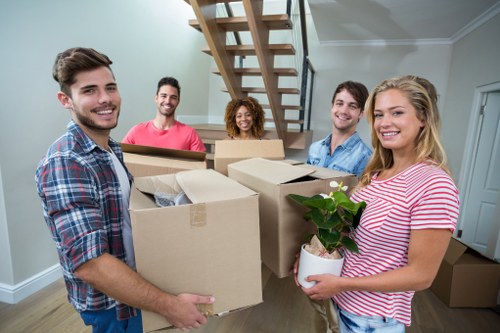 Professional movers carrying furniture during a Catford house move