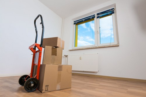 Packed household boxes and wrapped furniture ready for removal in Catford