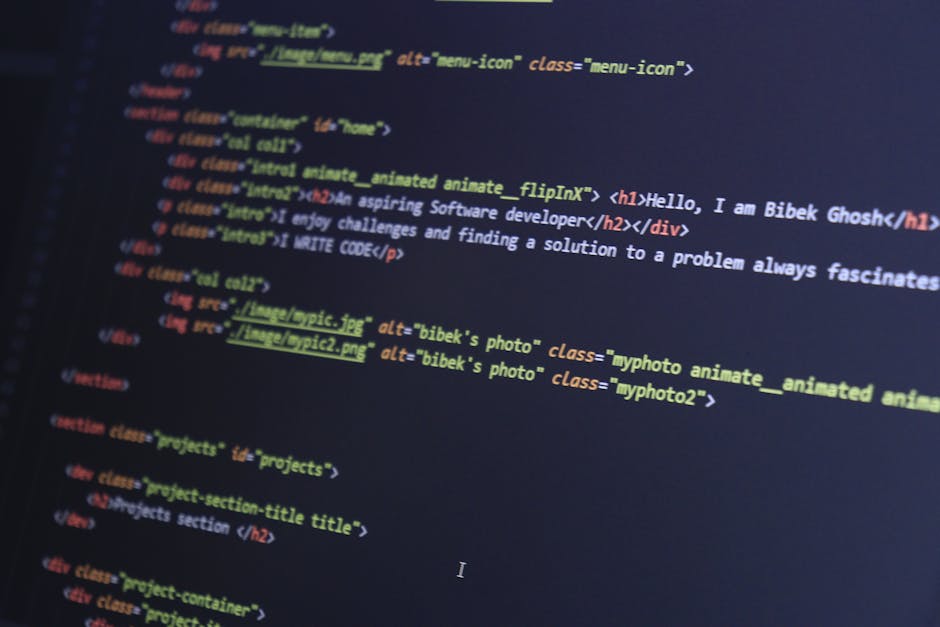 Close-up of a person's hands typing on a laptop keyboard, which displays a dark-themed coding interface with multiple lines of code and text. The laptop is positioned on a dark surface, possibly a tab